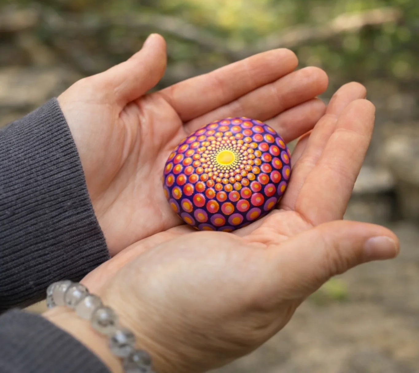 a mandala stone left behind in the forest