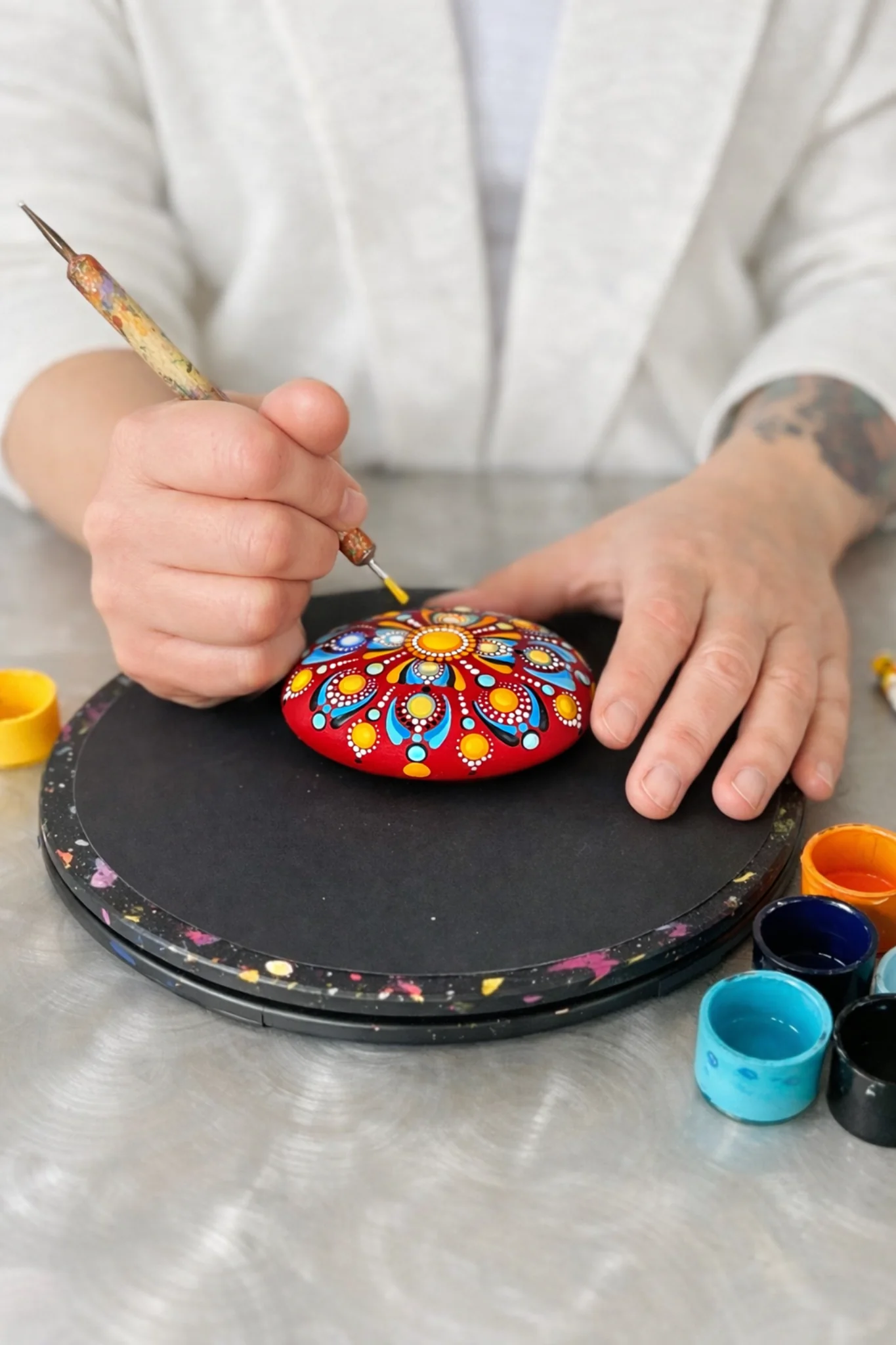 painting a dot mandala stone